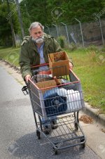9485850-Homeless-Vietnam-veteran-pushes-a-shopping-cart-containing-his-possessions-down-the-side.jpg